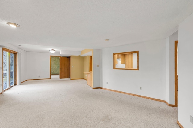 empty room with light colored carpet and baseboards