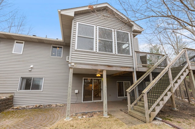rear view of property with stairs, a patio area, and a deck