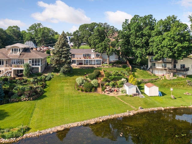 birds eye view of property with a water view