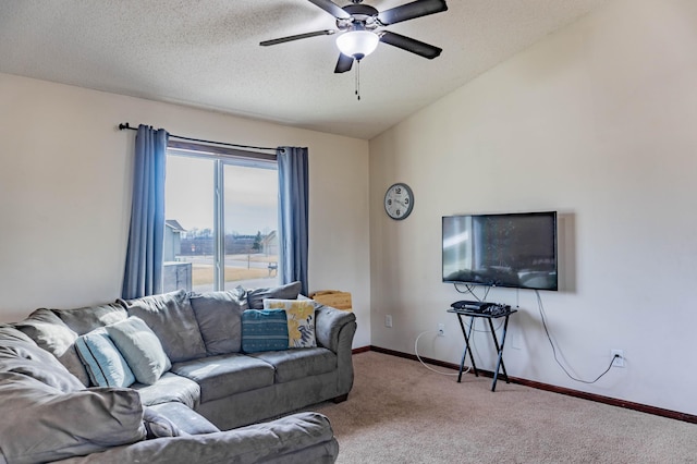 carpeted living area with a textured ceiling, baseboards, vaulted ceiling, and a ceiling fan