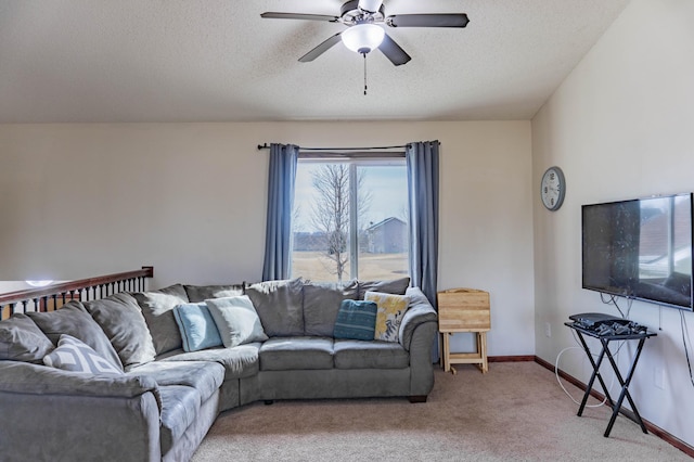 carpeted living room with a textured ceiling, a ceiling fan, and baseboards