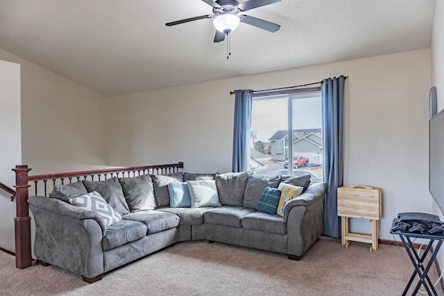 carpeted living area with a textured ceiling, a ceiling fan, and baseboards