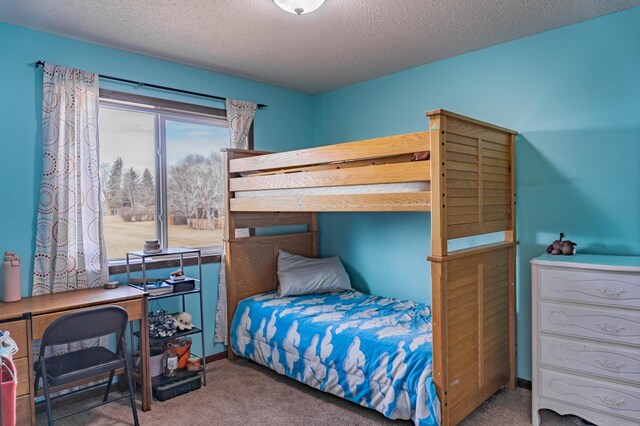 bedroom with carpet flooring and a textured ceiling