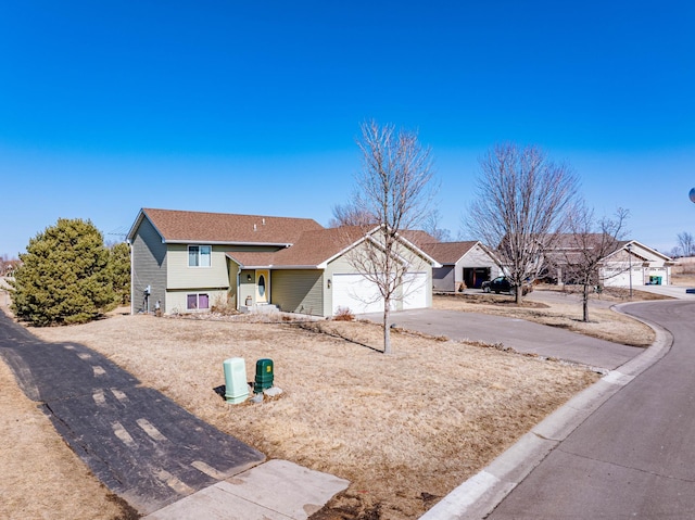 view of front facade with a garage and concrete driveway