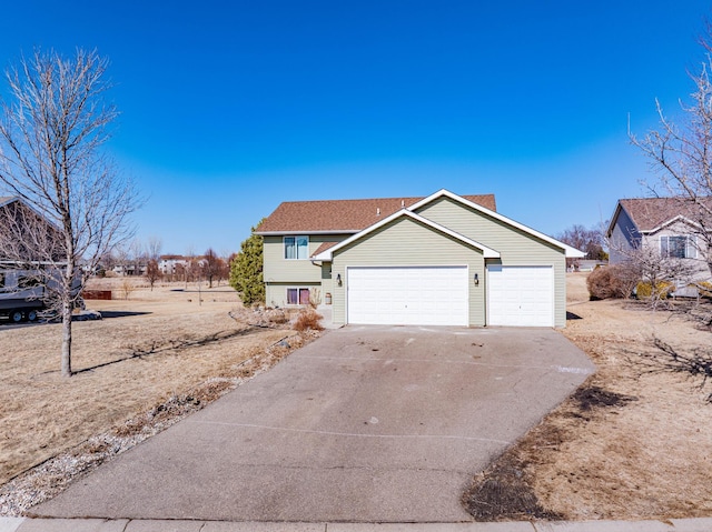 view of front of home with concrete driveway and an attached garage