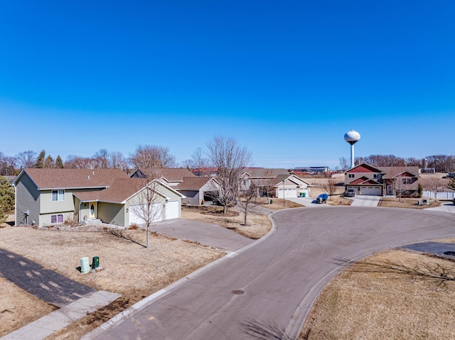 view of road with curbs, street lighting, and a residential view