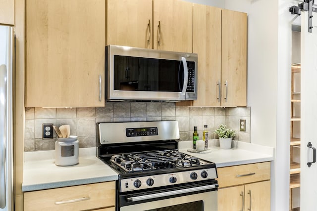 kitchen featuring stainless steel appliances, decorative backsplash, and light brown cabinetry