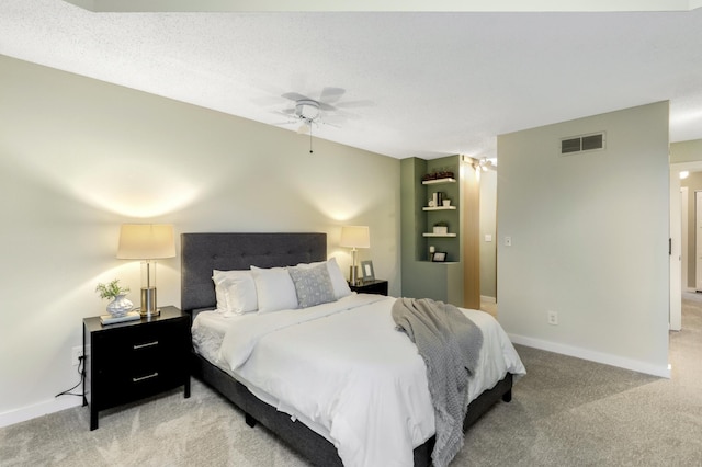 bedroom featuring carpet floors, visible vents, and baseboards