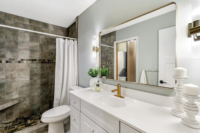 full bathroom featuring toilet, tiled shower, and vanity