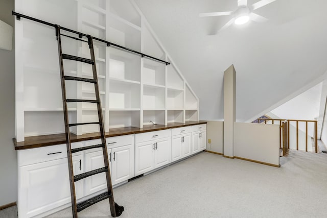 interior space featuring light carpet, ceiling fan, and lofted ceiling