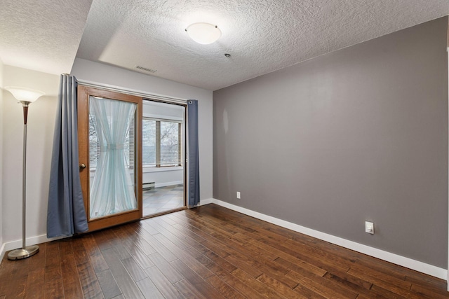 unfurnished room with baseboards, a textured ceiling, visible vents, and dark wood-style flooring