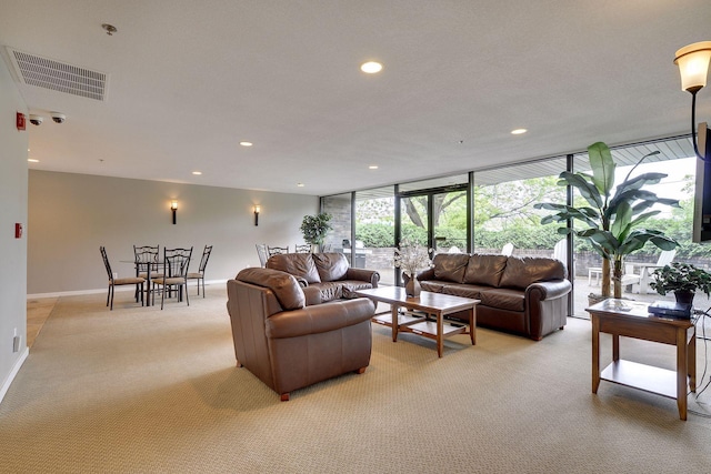 living area with light carpet, baseboards, visible vents, expansive windows, and recessed lighting