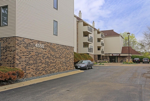 view of property featuring uncovered parking