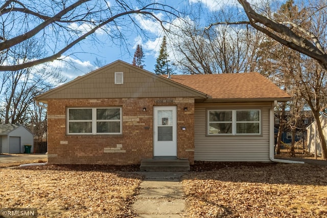 bungalow with crawl space, entry steps, roof with shingles, and brick siding