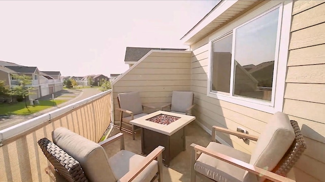 balcony featuring a fire pit and a residential view