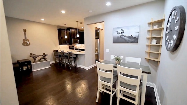 dining room with baseboards, dark wood-style flooring, and recessed lighting