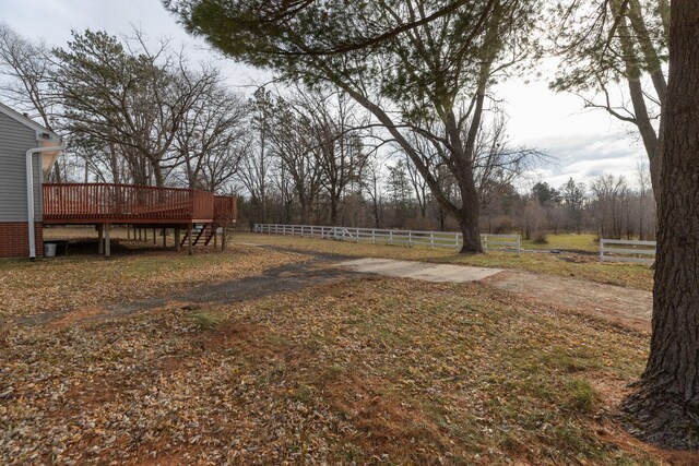 view of yard with fence and a wooden deck