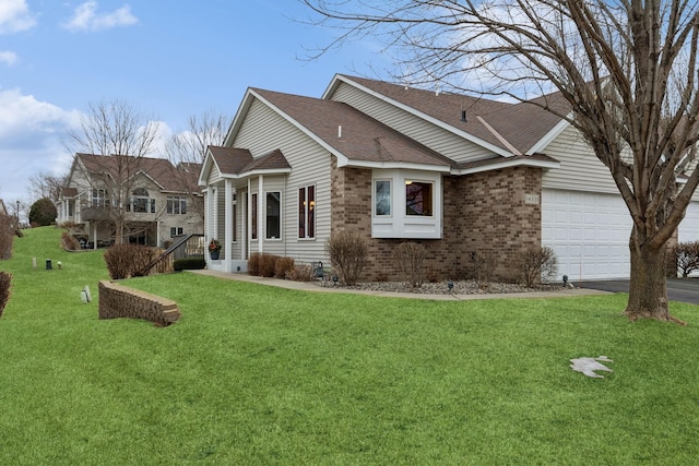 view of side of property featuring driveway, a lawn, roof with shingles, an attached garage, and brick siding