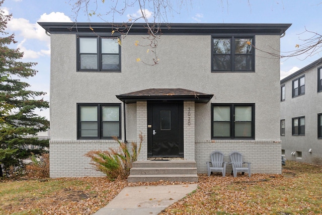 view of front facade with stucco siding and brick siding