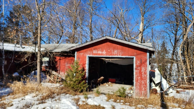 snow covered structure featuring an outdoor structure