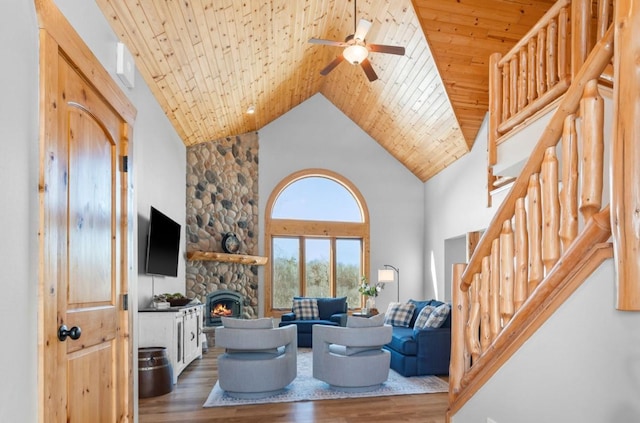 living area featuring stairs, wood finished floors, and wood ceiling