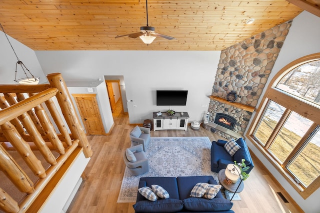 living area with high vaulted ceiling, wood finished floors, wood ceiling, and a healthy amount of sunlight