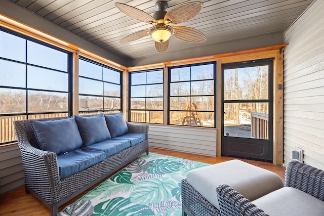 sunroom featuring wooden ceiling and a ceiling fan