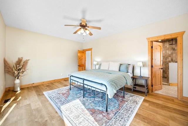 bedroom with ceiling fan, light wood-type flooring, visible vents, and baseboards