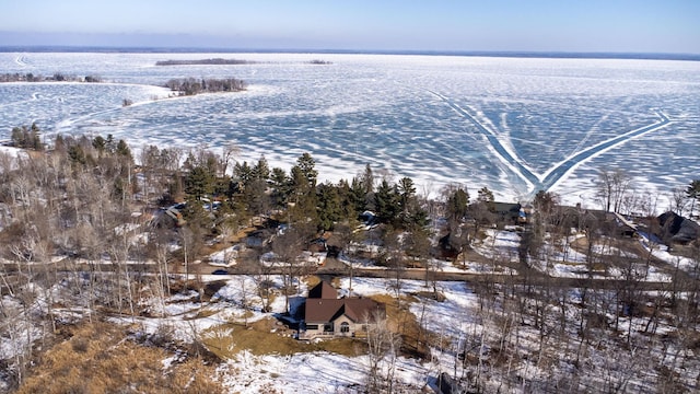 snowy aerial view with a water view