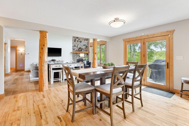 29235 Piney Way, Breezy Point, MN 56472 - dining room featuring light wood-style flooring and a stone fireplace