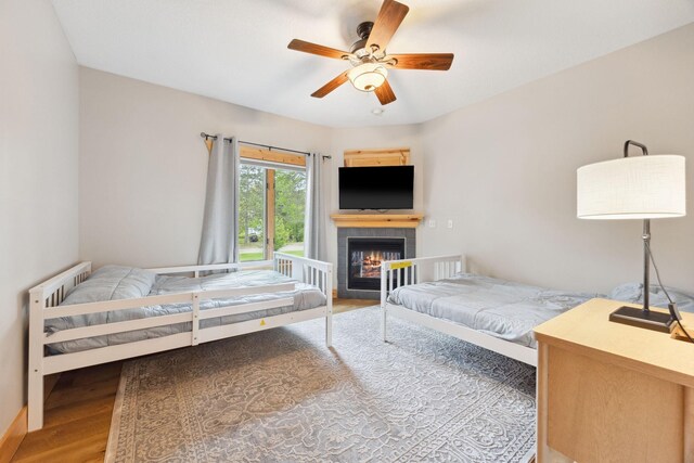 29235 Piney Way, Breezy Point, MN 56472 - bedroom with wood finished floors, a fireplace, and ceiling fan