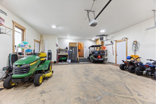 29235 Piney Way, Breezy Point, MN 56472 - garage featuring a garage door opener and stainless steel fridge with ice dispenser