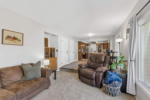 living room featuring baseboards and light colored carpet