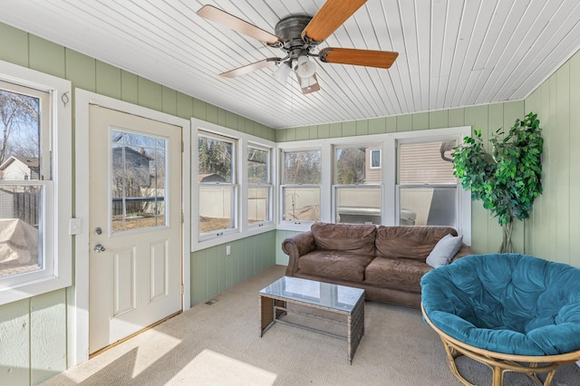 sunroom / solarium featuring ceiling fan and wood ceiling