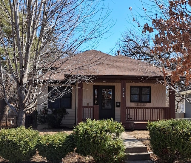 view of front of home featuring a porch and roof with shingles