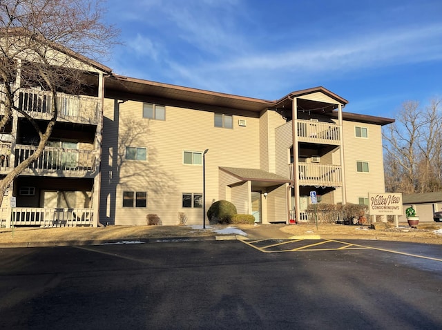 view of building exterior featuring uncovered parking