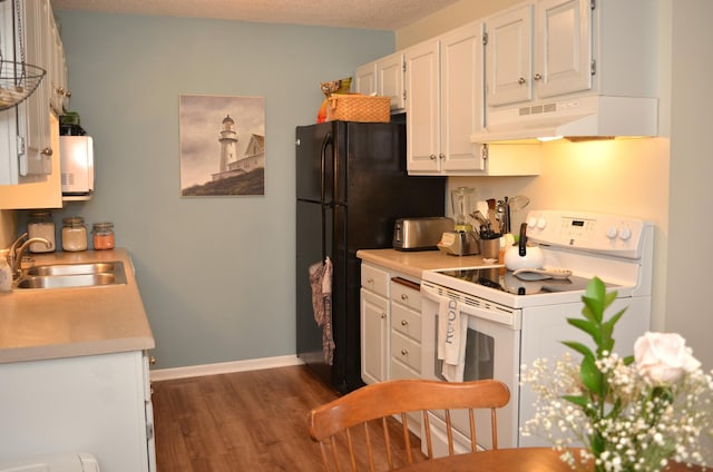 kitchen featuring under cabinet range hood, a sink, white cabinets, light countertops, and white range with electric stovetop