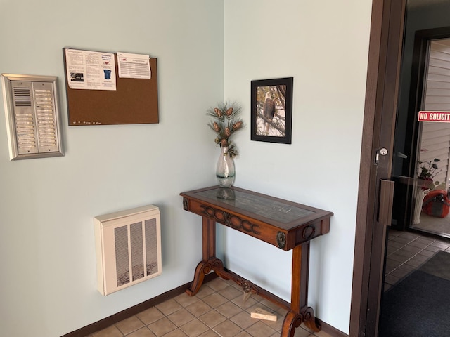 details featuring baseboards, visible vents, and heating unit