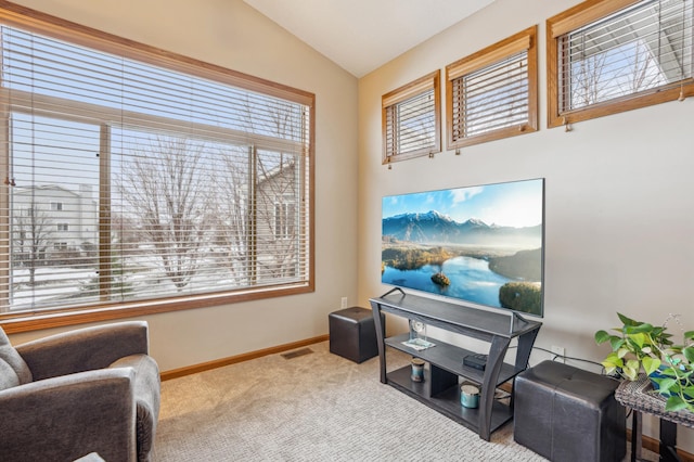sitting room with baseboards, carpet flooring, lofted ceiling, and visible vents