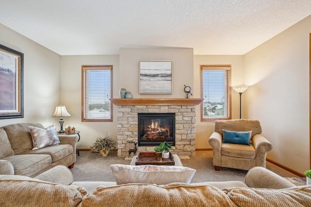carpeted living room featuring baseboards and a stone fireplace