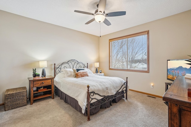 bedroom featuring baseboards, visible vents, light carpet, and ceiling fan