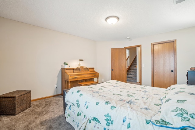 bedroom with carpet floors, a textured ceiling, baseboards, and a closet