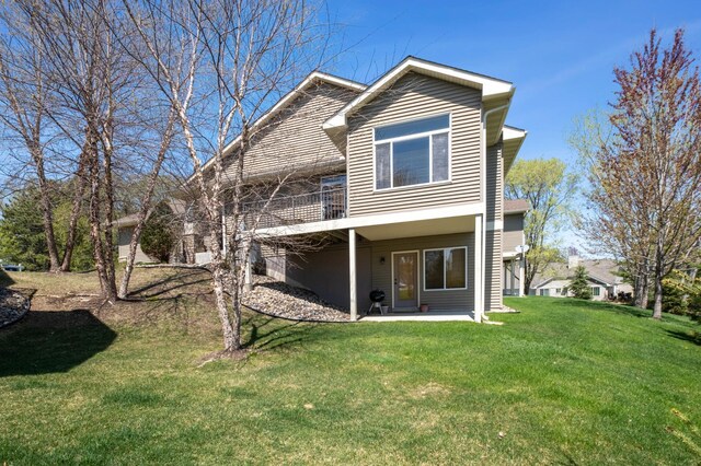 rear view of property with a patio area and a yard