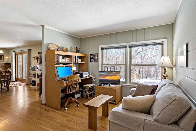 office featuring a textured ceiling, wood finished floors, and crown molding