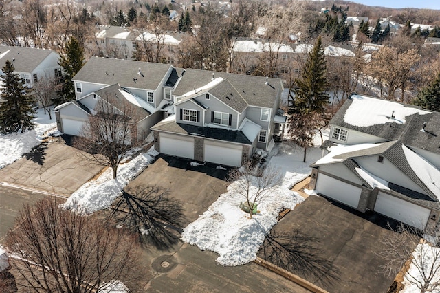 snowy aerial view with a residential view