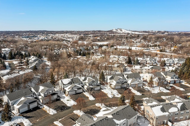 snowy aerial view with a residential view