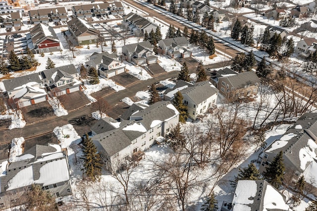 snowy aerial view featuring a residential view