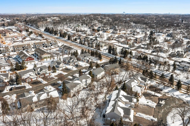 snowy aerial view featuring a residential view