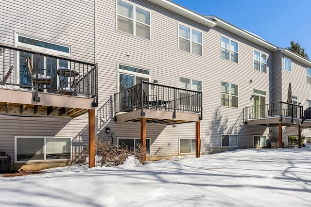 view of snow covered rear of property