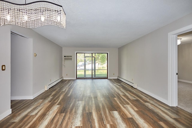 unfurnished living room with a baseboard radiator, dark wood finished floors, and an AC wall unit